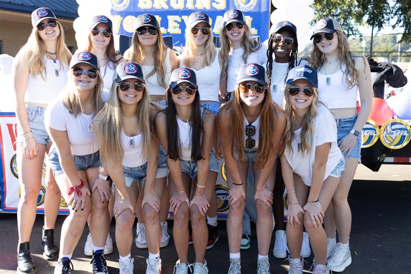 Students ride on a homecoming parade float